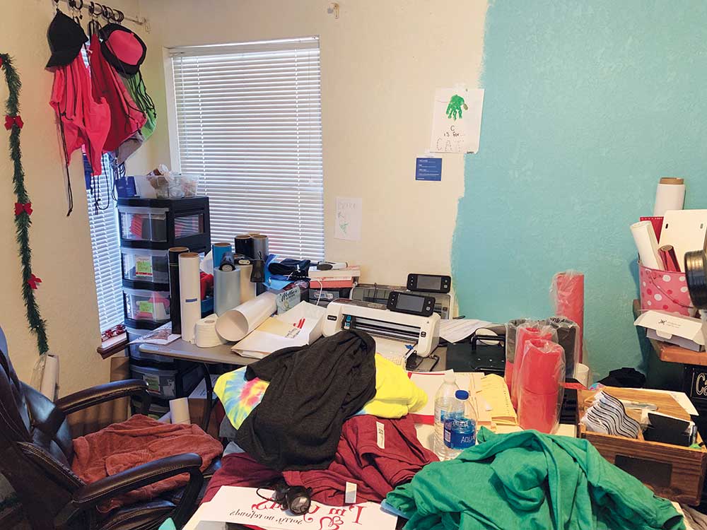 A cluttered room with many items on the floor.