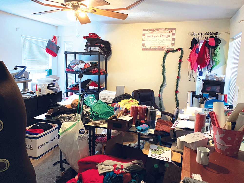 A cluttered room with many items on the floor.