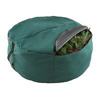 A green bag with a bunch of christmas trees inside