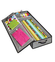A drawer with wrapping paper and other items in it.