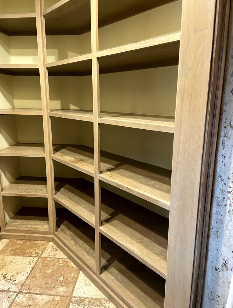 A wooden shelf with many shelves in it