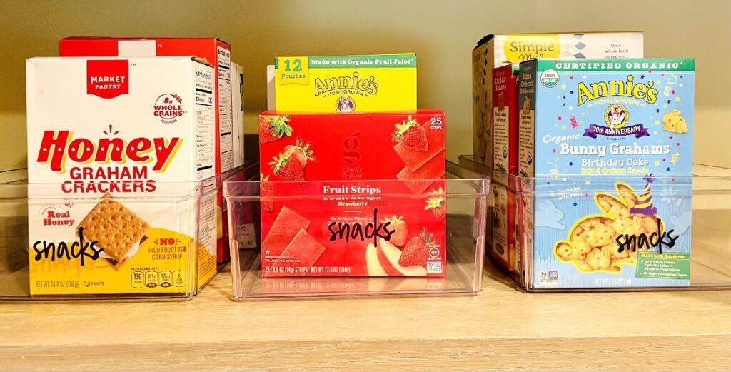 A shelf with cereal boxes and snacks on it.