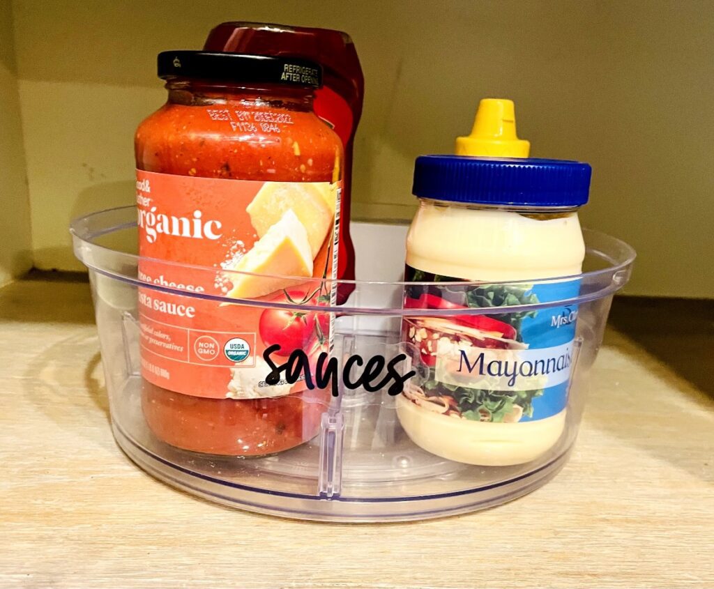 A bowl of sauces and mayonnaise on the counter.