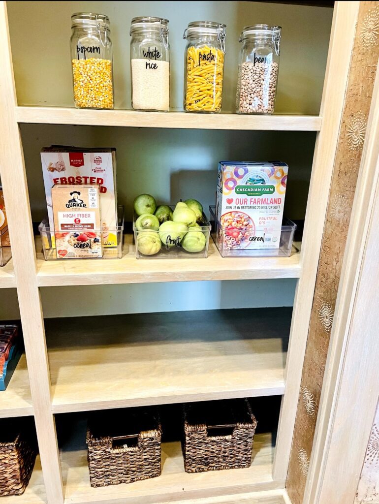 A shelf with apples and popcorn on it.