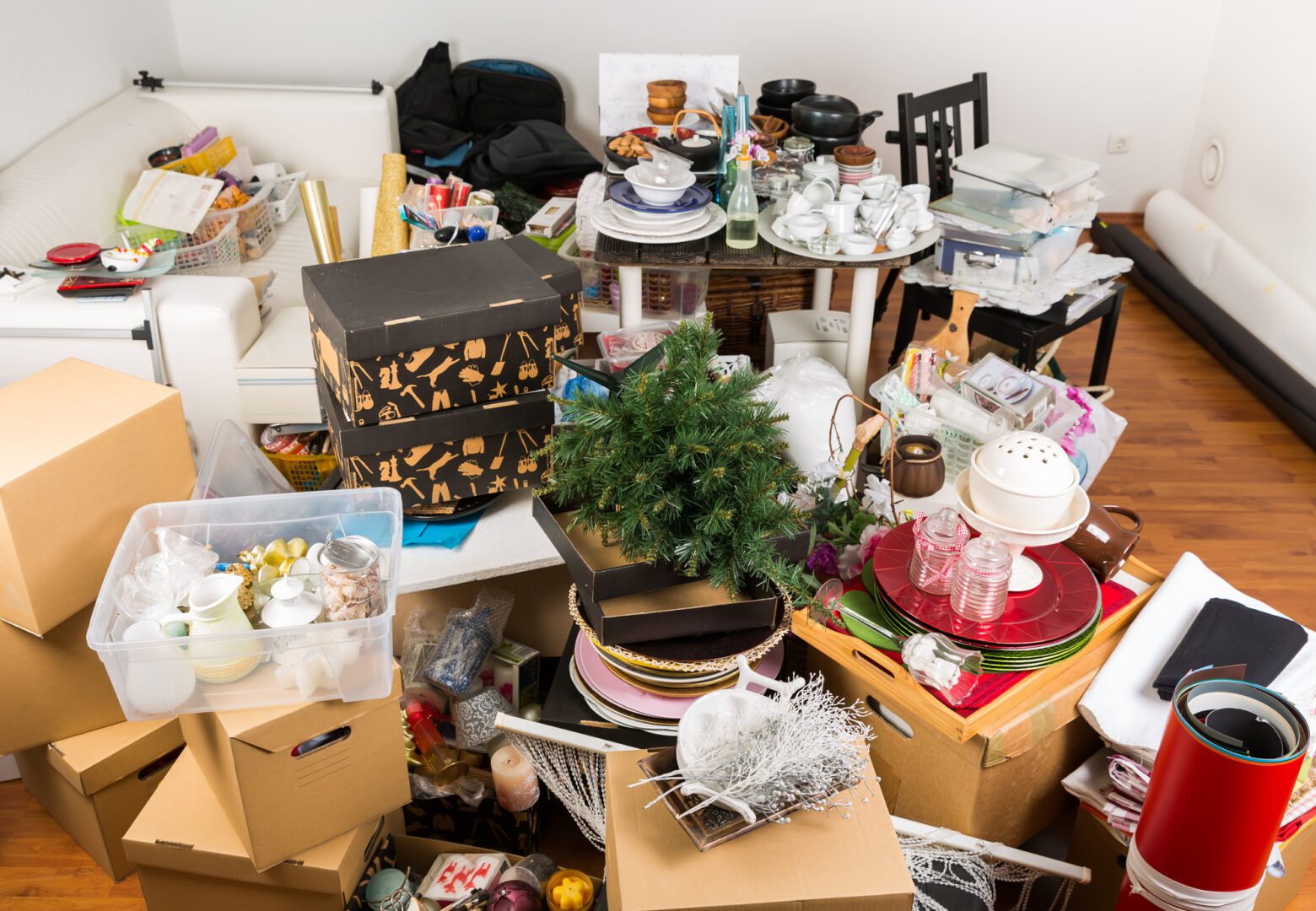 A cluttered room with many boxes and other items.