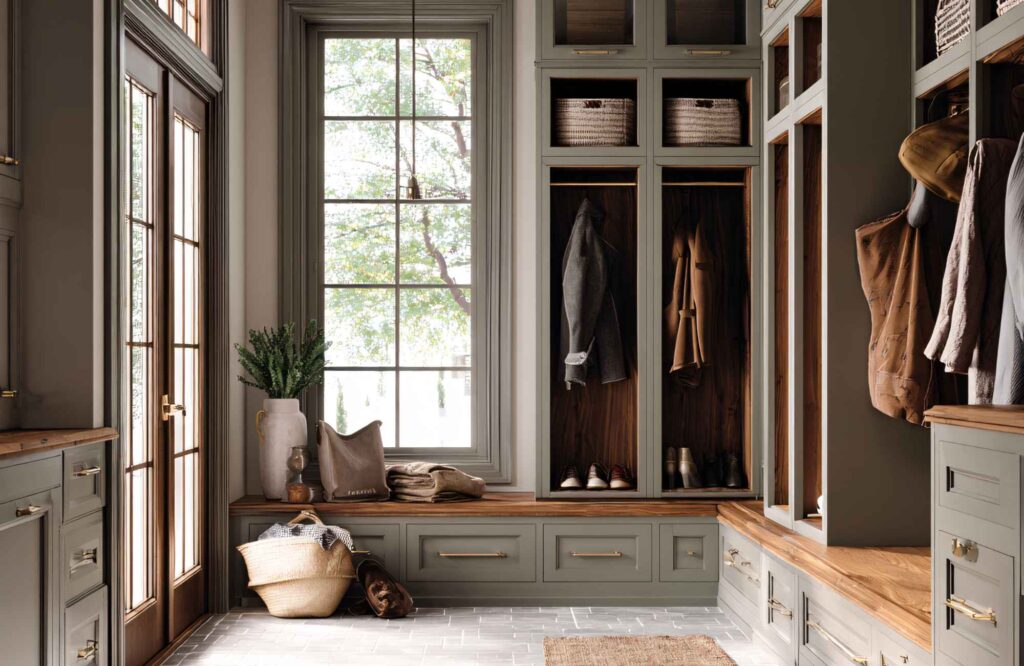 pretty-neat-yukon-ok-how-organization-transforms-daily-life-spacious-mudroom-with-built-in-cubbies-shelves-with-bins-deep-green-large-window-calm