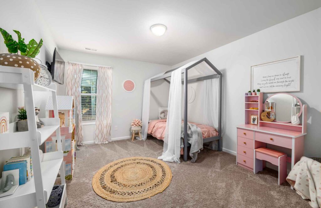 pretty-neat-edmond-ok-organizing-kids-bedrooms-girls-room-with-framed-bed-pink-vanity-round-rug-shelves-with-plants-calm-office-organization