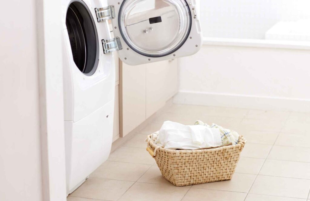 professional-home-organizing-yukon-ok-laundry-room-organization-tips-open-dryer-with-laundry-basket-clean-clothes-well-being