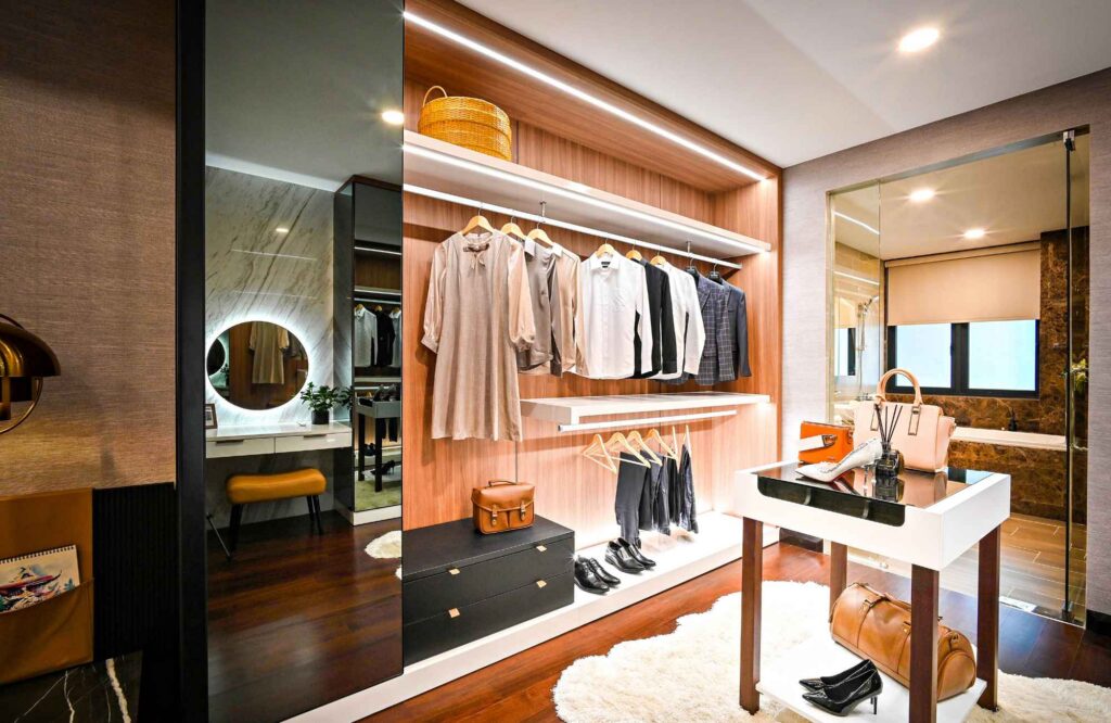 pretty-neat-nichols-hills-ok-seasonal-closet-organization-well-lit-closet-dark-wood-hanging-clothes-table-with-accessories-comfortable