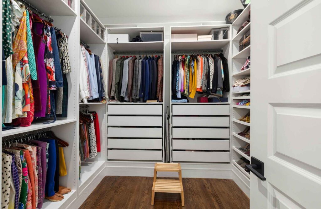 professional-home-organizer-oklahoma-city-ok-seasonal-closet-organization-walk-in-closet-with-hanging-clothes-drawers-and-shelves-reduce-stress