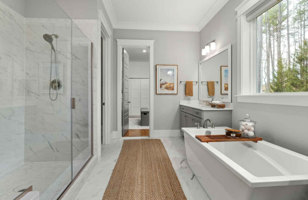 professional-home-organizer-yukon-ok-summer-decluttering-neat-tidy-bathroom-glass-shower-gray-and-white-window-over-tub-reduce-stress