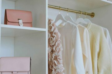 professional-home-organizing-edmond-ok-seasonal-closet-organization-womans-closet-pastel-shirts-pink-purses-on-shelves-well-being