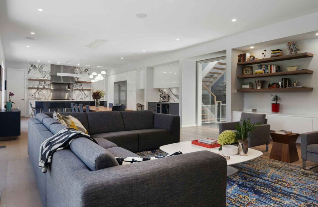 professional-home-organizer-moore-ok-pre-renovation-organizing-open-concept-living-and-kitchen-dark-sofa-floating-shelves-comfortable